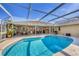 The pool is surrounded by an outdoor seating area, accessible from multiple doors in the house at 5507 Country Lakes Trl, Sarasota, FL 34243