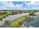 Aerial view of a canal-front home with private pool and spa; community view at 5703 52Nd W Ave, Bradenton, FL 34210