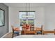 Bright dining room features a wood table and chairs, modern light fixture, and large window at 5703 52Nd W Ave, Bradenton, FL 34210