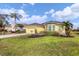 House exterior showcasing a manicured lawn, palm trees, and a yellow facade at 5703 52Nd W Ave, Bradenton, FL 34210