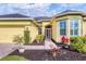 Front entrance of a yellow house with a walkway, landscaping, and a mailbox at 5703 52Nd W Ave, Bradenton, FL 34210