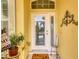 Front door entry with welcome mat and potted plants at 5703 52Nd W Ave, Bradenton, FL 34210