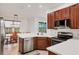 Modern kitchen with stainless steel appliances, white countertops, and wood cabinets at 5703 52Nd W Ave, Bradenton, FL 34210