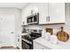 Stainless steel appliances and white shaker cabinets in kitchen at 5703 Tripoli Dr, Palmetto, FL 34221