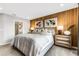 Main bedroom with wood accent wall, king-size bed and ensuite bathroom at 5703 Tripoli Dr, Palmetto, FL 34221