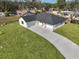 Aerial view of a house with a gray roof and driveway at 5923 22Nd Avenue E Dr, Palmetto, FL 34221