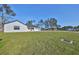 Newly built home with white siding, gray roof, and a spacious lawn at 5923 22Nd Avenue E Dr, Palmetto, FL 34221