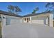 Two-car garage with white doors and a long driveway at 5923 22Nd Avenue E Dr, Palmetto, FL 34221