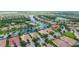 Expansive aerial view of a community, showcasing homes with water views and lush landscaping at 6063 Benevento Dr, Sarasota, FL 34238