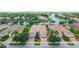 Aerial view of a single-story home with a tile roof, surrounded by lush landscaping at 6063 Benevento Dr, Sarasota, FL 34238