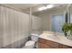 Well-lit bathroom with a double vanity, framed mirror, and separate shower area at 6063 Benevento Dr, Sarasota, FL 34238