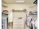 Walk-in closet with ample hanging space, shelving, and a central dresser unit at 6063 Benevento Dr, Sarasota, FL 34238