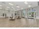 Bright event space with high ceilings, wood flooring, and arched windows, ideal for gatherings and community events at 6063 Benevento Dr, Sarasota, FL 34238