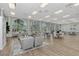 Bright event space with high ceilings, wood flooring, and arched windows, ideal for gatherings and community events at 6063 Benevento Dr, Sarasota, FL 34238