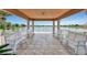 Scenic lake view from a covered pavilion with seating and a view of a pristine lake, perfect for relaxation at 6063 Benevento Dr, Sarasota, FL 34238