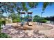 A lovely playground area with slides and climbing structures, nestled in a landscaped setting for enjoyment at 6063 Benevento Dr, Sarasota, FL 34238