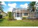 View of a private pool and patio area, enclosed with screens and surrounded by lush greenery at 6063 Benevento Dr, Sarasota, FL 34238