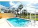 Screened in pool area with bright blue water, palm trees, and view of the pond at 6063 Benevento Dr, Sarasota, FL 34238