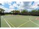 A well-maintained tennis and basketball court with net and landscaping offers a recreational space in this community at 6063 Benevento Dr, Sarasota, FL 34238