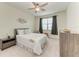 Bright bedroom with window, ceiling fan, and ample closet space at 6086 Worsham Ln # 102, Bradenton, FL 34211