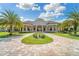 Grand community center entrance with palm trees and landscaping at 6086 Worsham Ln # 102, Bradenton, FL 34211