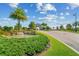 Landscaped entrance to a residential community with palm trees at 6086 Worsham Ln # 102, Bradenton, FL 34211