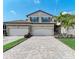 Two-story home with a two-car garage and paver driveway at 6086 Worsham Ln # 102, Bradenton, FL 34211