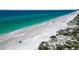 Aerial view of pristine beach with turquoise water at 611 Cedars Ct, Longboat Key, FL 34228