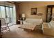 Living room with beige walls, off-white couches, and a large stone coffee table at 611 Cedars Ct, Longboat Key, FL 34228