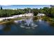 Aerial view of pond with fountain in a tropical setting at 611 Cedars Ct, Longboat Key, FL 34228