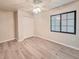 Bedroom with double door closet, ceiling fan, and wood-look flooring at 613 Chevy Chase Dr, Sarasota, FL 34243