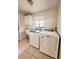 Laundry room with washer, dryer, and cabinets at 613 Chevy Chase Dr, Sarasota, FL 34243