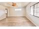 Living room with ceiling fan, wood-look floors, and large window at 613 Chevy Chase Dr, Sarasota, FL 34243