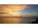 Stunning sunset over the ocean with beach and distant boat at 613 Chevy Chase Dr, Sarasota, FL 34243