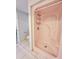 Pink shower stall with tiled floor and built in shelving at 613 Chevy Chase Dr, Sarasota, FL 34243