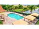 Resort-style pool with shaded seating and lounge chairs, overlooking a lake at 6207 27Th E St, Ellenton, FL 34222