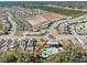 Wide aerial shot of a new residential community, showcasing a pool area and community spaces near homes at 6218 Apple Snail Ave, New Port Richey, FL 34653