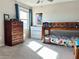 Bedroom featuring a bunk bed, natural light from the window, and dressers for storage, perfect for a room at 6218 Apple Snail Ave, New Port Richey, FL 34653