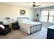 Serene bedroom featuring a metal-frame bed, soft carpet, and a ceiling fan for added comfort and style at 6218 Apple Snail Ave, New Port Richey, FL 34653