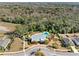 Aerial shot of a community pool area featuring a stylish lounge and surrounding trees, showcasing the home at 6218 Apple Snail Ave, New Port Richey, FL 34653