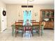 Cozy dining room featuring a rustic table, chandelier lighting, and a vintage china cabinet at 6218 Apple Snail Ave, New Port Richey, FL 34653