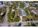 Aerial view showcasing a charming light blue single story home nestled within a residential area at 651 Fox St, Longboat Key, FL 34228