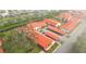 Aerial view of a community with red tile roofs, parking, and landscaping at 6666 Draw Ln # 132, Sarasota, FL 34238