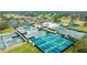 Aerial view features multiple tennis and pickleball courts along with lush landscapes and ample parking at 6939 W Country Club N Dr # 158, Sarasota, FL 34243