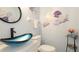 Charming bathroom with vessel sink, modern faucet, and floral wall decor at 6939 W Country Club N Dr # 158, Sarasota, FL 34243