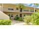 Exterior view of condo building with mature landscaping and welcoming entrance at 6939 W Country Club N Dr # 158, Sarasota, FL 34243