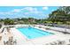 Resort-style community pool with ample seating, umbrellas, and lush landscaping for ultimate relaxation at 6939 W Country Club N Dr # 158, Sarasota, FL 34243