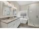 Bathroom with double vanity, granite countertop, and walk-in shower at 6978 Superior Street Cir, Sarasota, FL 34243