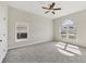 Bright bedroom with neutral carpeting and an arched window at 6978 Superior Street Cir, Sarasota, FL 34243