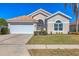 One-story house with tan walls, tile roof, and a two-car garage at 6978 Superior Street Cir, Sarasota, FL 34243